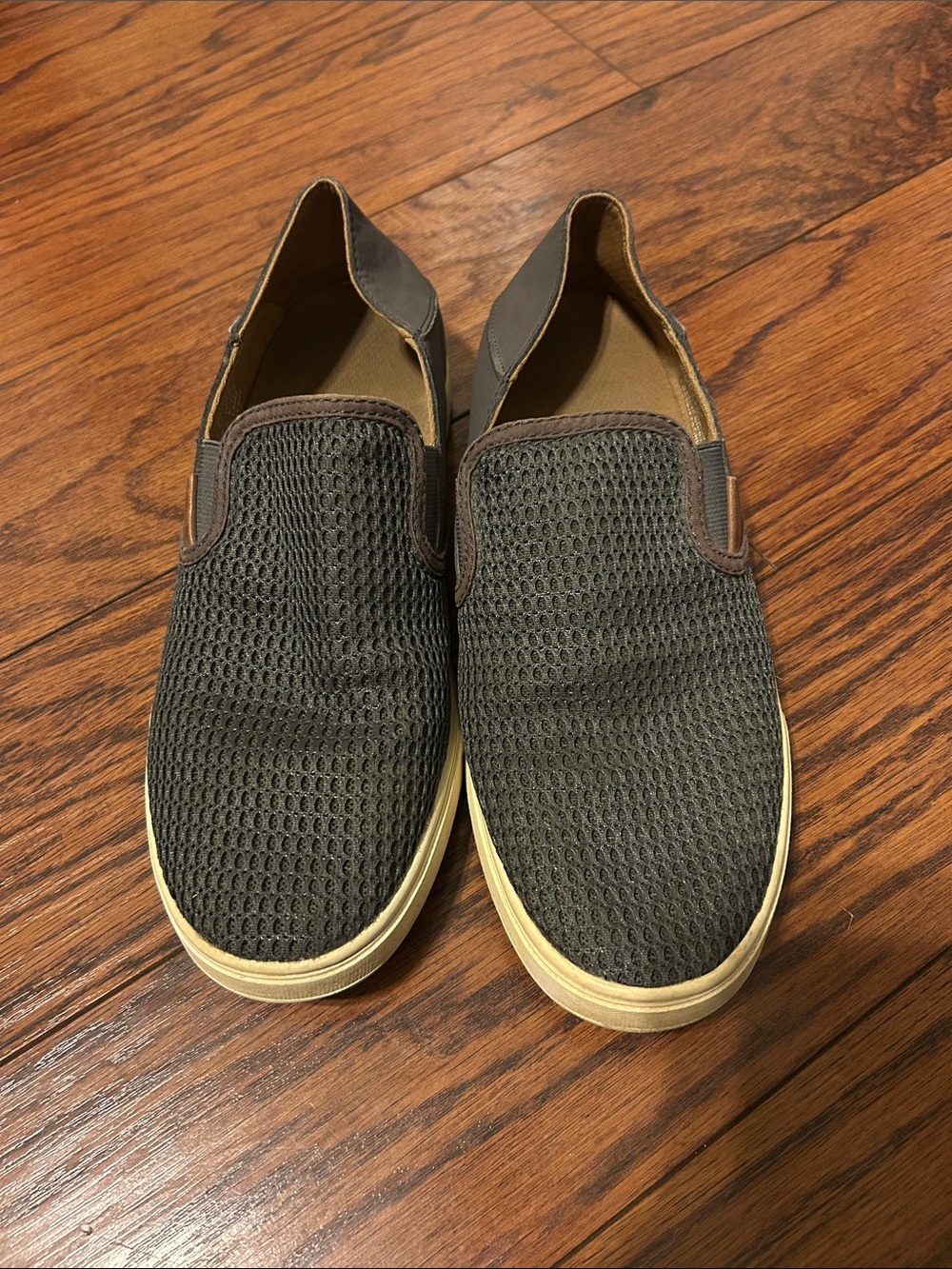 Women’s Olukai gray slip on shoes.